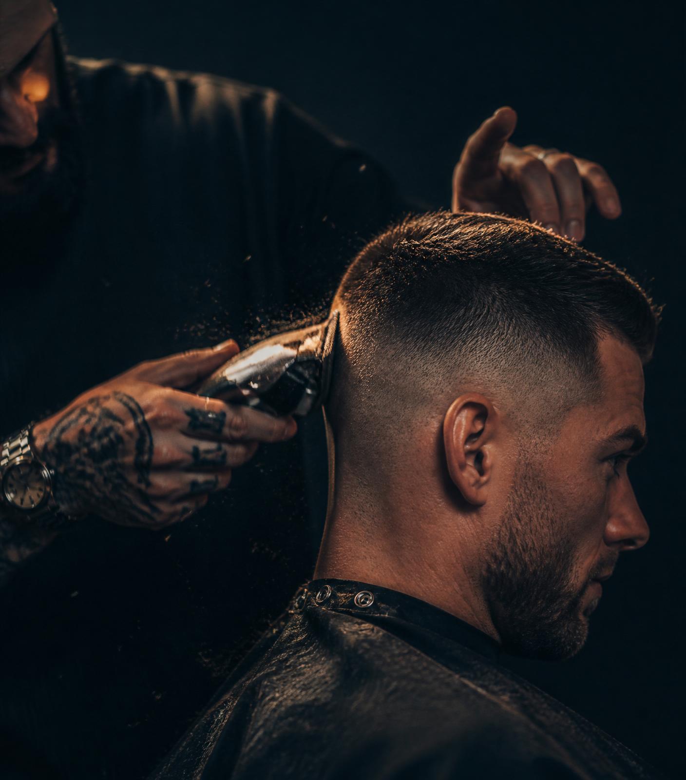 Barber shaping a fade with clippers